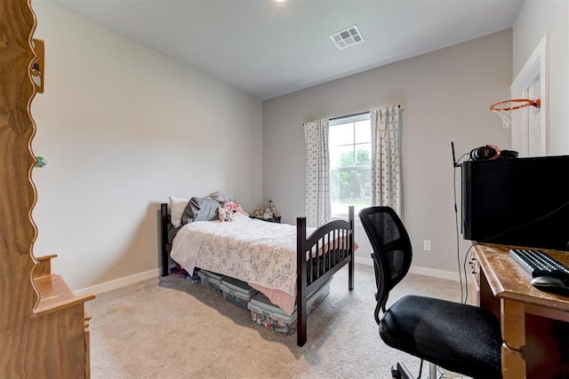 bedroom featuring baseboards, visible vents, and light carpet