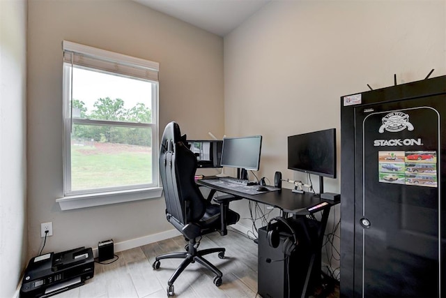 office space with baseboards and wood finished floors