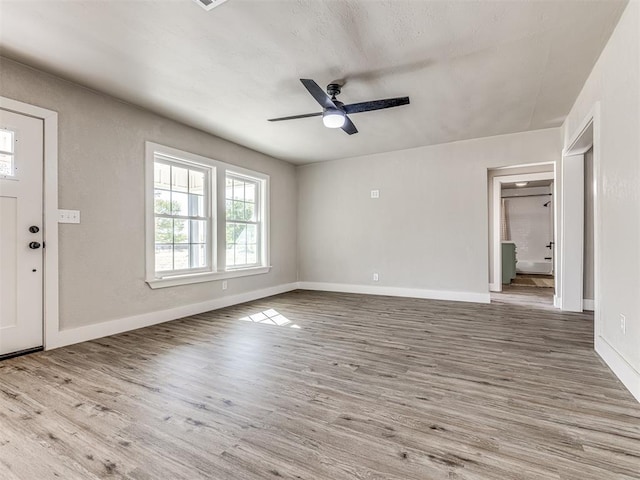 foyer with a ceiling fan, baseboards, and wood finished floors