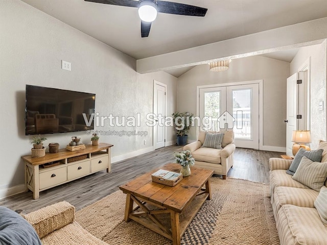 living area with baseboards, french doors, wood finished floors, and lofted ceiling