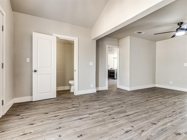 empty room featuring baseboards, ceiling fan, visible vents, and wood finished floors