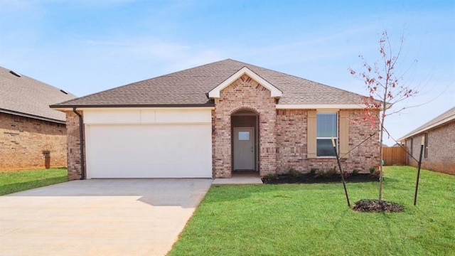 10232 NW 28th St, Yukon, OK 73099 - ranch-style home featuring roof with shingles, brick siding, a garage, a front yard, and driveway