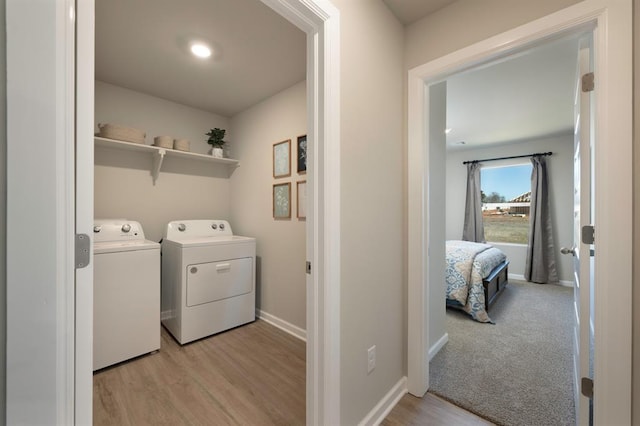10232 NW 28th St, Yukon, OK 73099 - laundry room featuring laundry area, baseboards, light wood finished floors, and washing machine and dryer