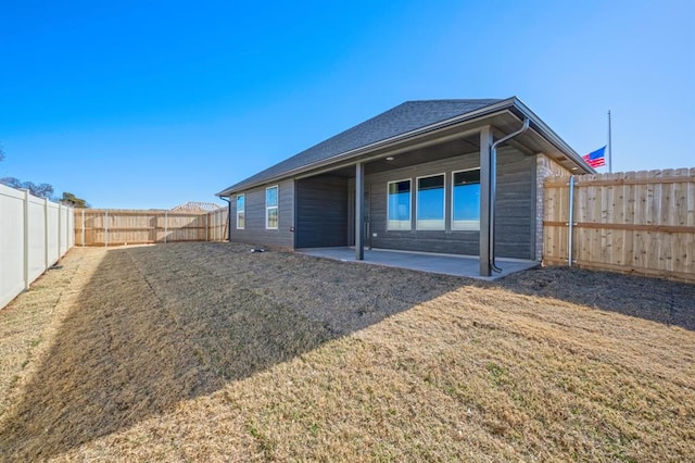 10232 NW 28th St, Yukon, OK 73099 - back of property featuring a lawn, a fenced backyard, and a patio area