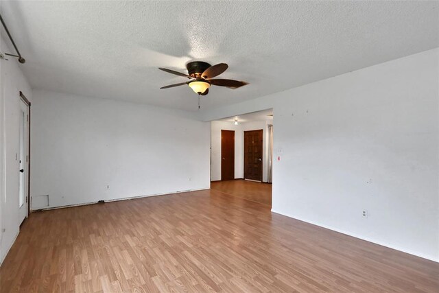 208 Harrogate Dr, Yukon, OK 73099 - empty room with a ceiling fan, light wood-style flooring, a textured ceiling, and baseboards