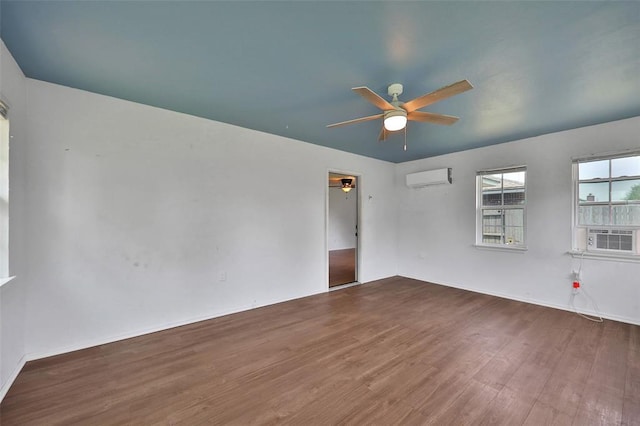 208 Harrogate Dr, Yukon, OK 73099 - empty room featuring a wall mounted AC, ceiling fan, wood finished floors, cooling unit, and baseboards