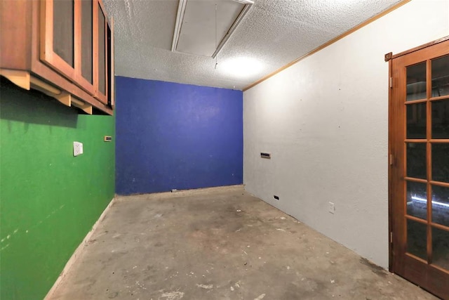 208 Harrogate Dr, Yukon, OK 73099 - spare room with attic access, concrete floors, and a textured ceiling