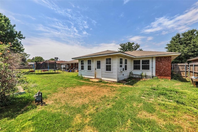 208 Harrogate Dr, Yukon, OK 73099 - rear view of house with a trampoline and brick siding