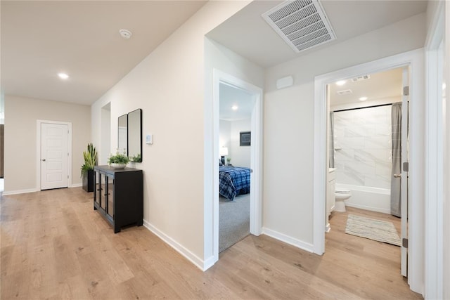 corridor with visible vents, recessed lighting, light wood finished floors, and baseboards