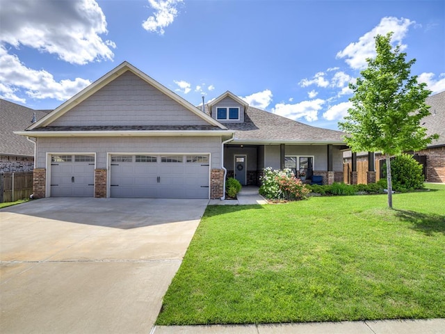 craftsman house with brick siding, a garage, a front lawn, and driveway