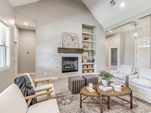 living area with light wood finished floors, built in shelves, recessed lighting, baseboards, and visible vents