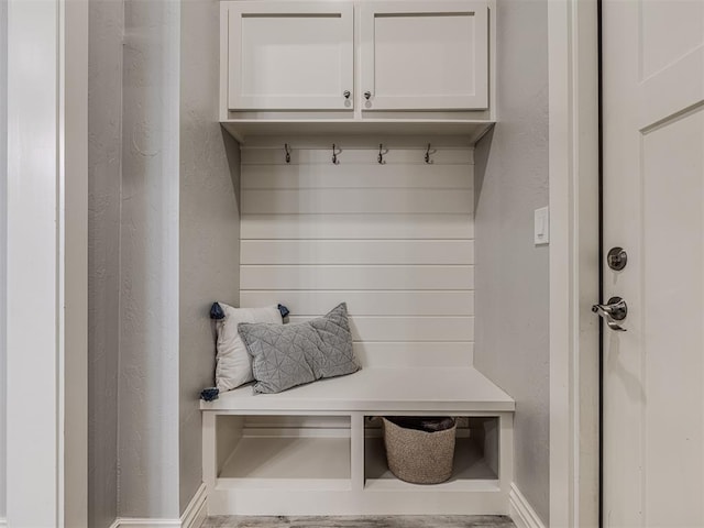 mudroom with baseboards and a textured wall