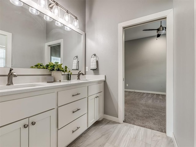 bathroom featuring double vanity, a ceiling fan, a sink, and marble finish floor