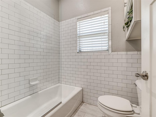 full bathroom featuring toilet, tile walls, and marble finish floor