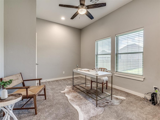 carpeted office featuring baseboards, a ceiling fan, and visible vents