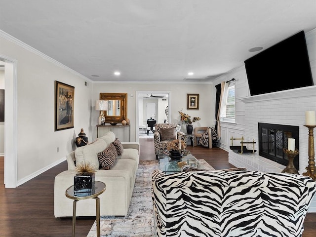 living area with ornamental molding, a brick fireplace, wood finished floors, baseboards, and recessed lighting