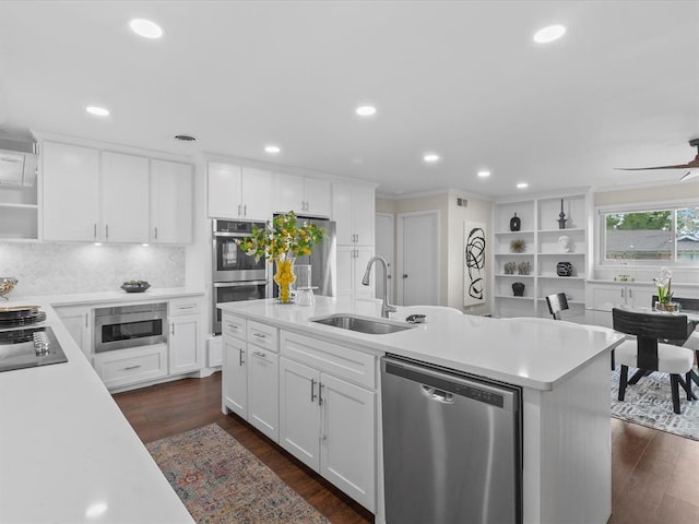 kitchen with open shelves, a sink, light countertops, stainless steel appliances, and white cabinetry