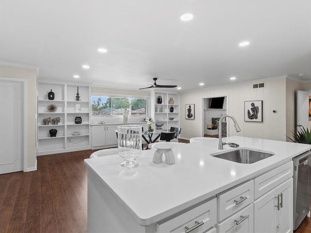 kitchen with stainless steel dishwasher, a ceiling fan, visible vents, ornamental molding, and a sink