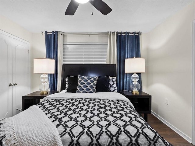 bedroom with a ceiling fan, baseboards, and wood finished floors