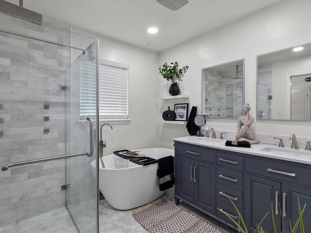 bathroom featuring double vanity, a freestanding bath, a sink, and a stall shower
