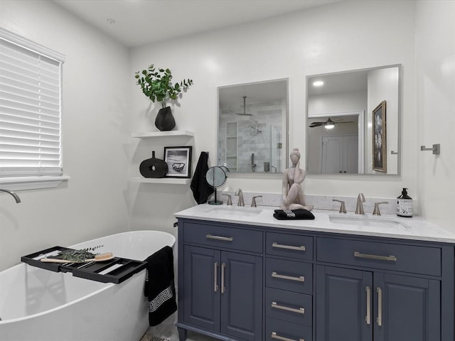 bathroom featuring double vanity, a sink, a shower, and a soaking tub