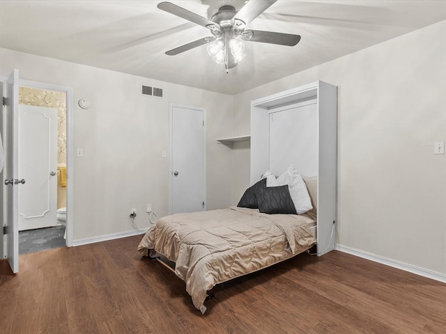 bedroom with ceiling fan, baseboards, visible vents, and wood finished floors