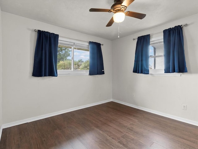 empty room with baseboards, a ceiling fan, and wood finished floors