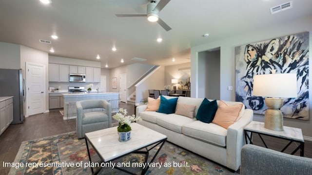living room with a ceiling fan, recessed lighting, visible vents, dark wood-style floors, and stairway