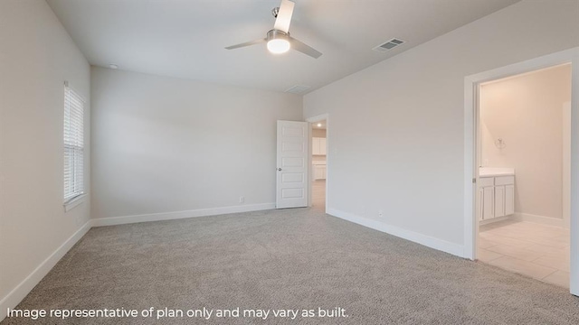unfurnished bedroom with a ceiling fan, visible vents, carpet floors, baseboards, and ensuite bath