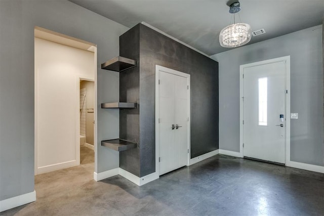 entryway with baseboards, visible vents, concrete floors, and a chandelier