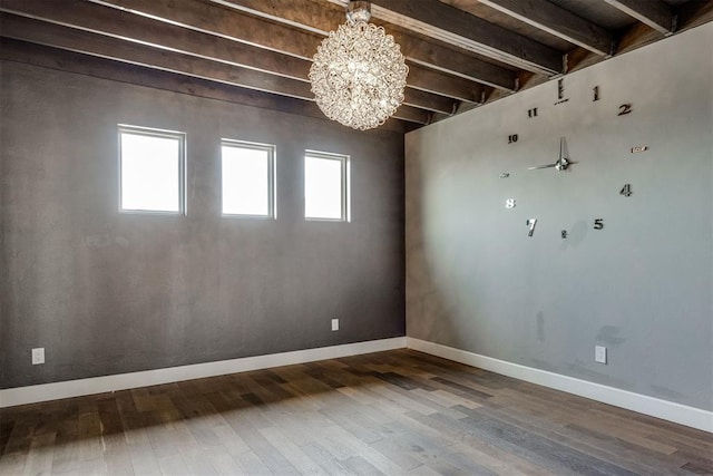 empty room featuring baseboards, beam ceiling, hardwood / wood-style floors, and a chandelier