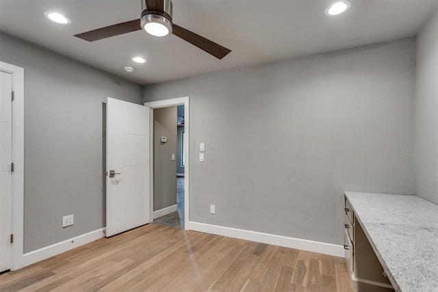 unfurnished bedroom with recessed lighting, baseboards, a ceiling fan, and light wood-style flooring