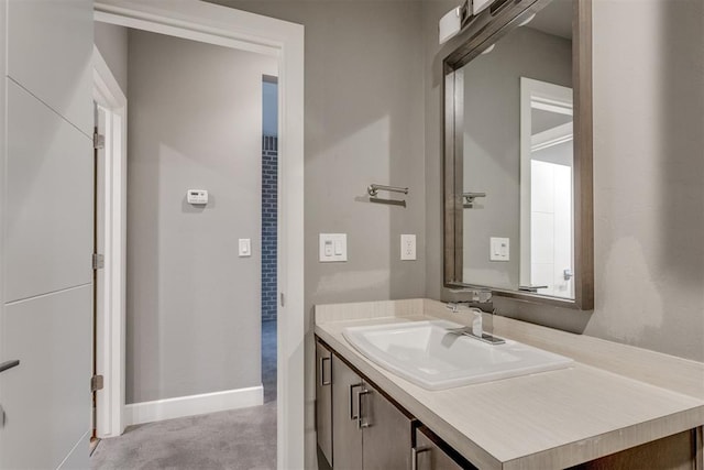 bathroom featuring baseboards and vanity
