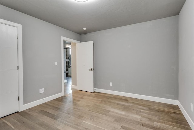 unfurnished bedroom with baseboards and light wood finished floors