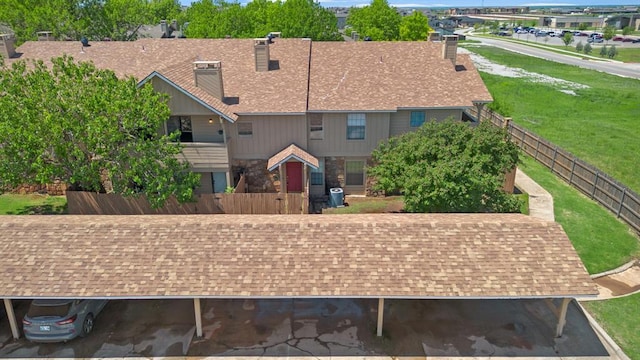 surrounding community with fence and a lawn