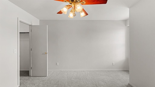 unfurnished bedroom featuring ceiling fan, baseboards, a closet, a spacious closet, and carpet