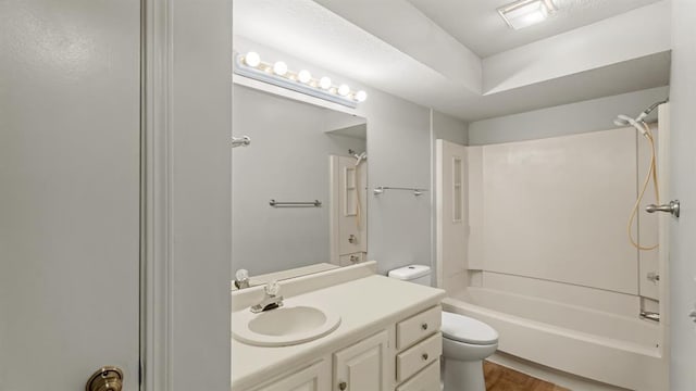 full bathroom featuring vanity, toilet, wood finished floors, and bathtub / shower combination
