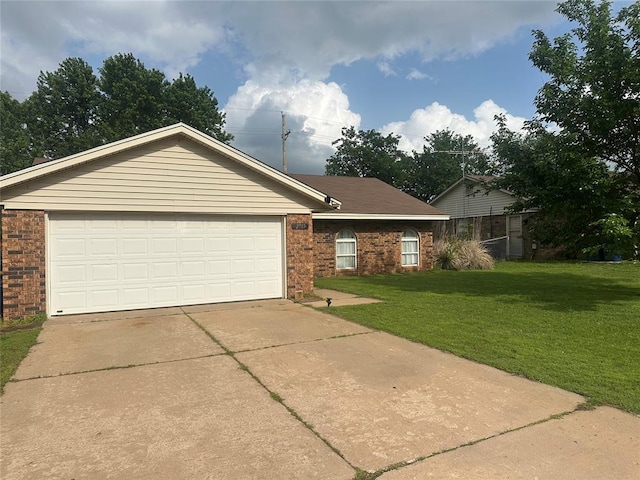 2719 N Park Cir, Stillwater, OK 74075 - view of front of house with brick siding, a garage, driveway, and a front lawn