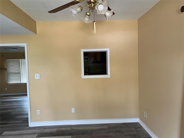 empty room featuring baseboards, ceiling fan, and wood finished floors