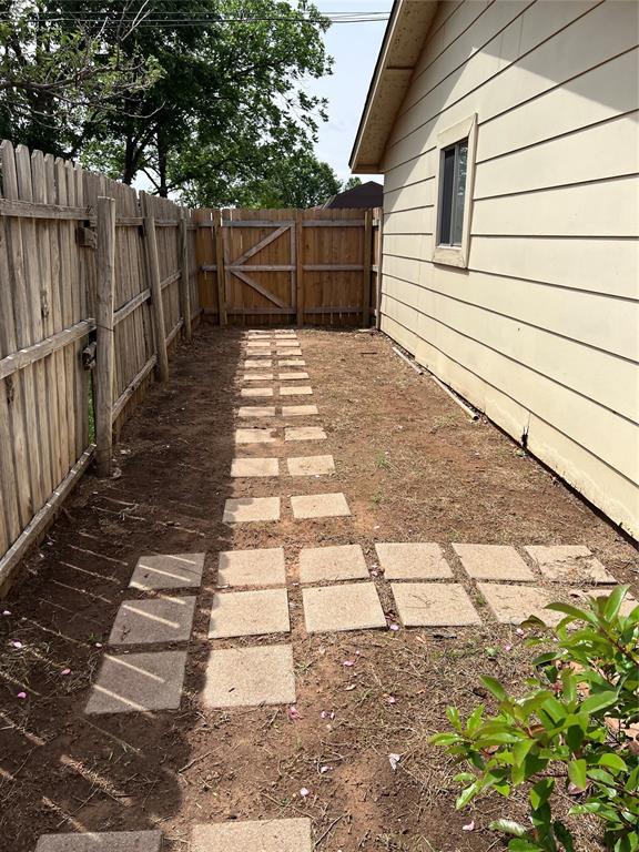 view of yard with fence and a gate