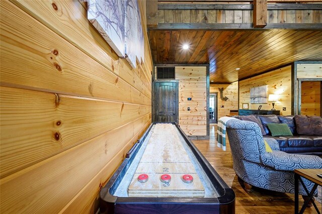 playroom featuring wooden walls, visible vents, wood ceiling, and wood-type flooring