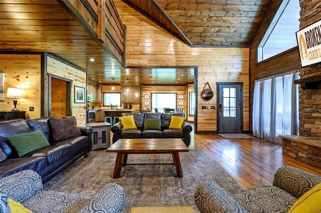 living area featuring plenty of natural light, wood walls, wood ceiling, and hardwood / wood-style flooring