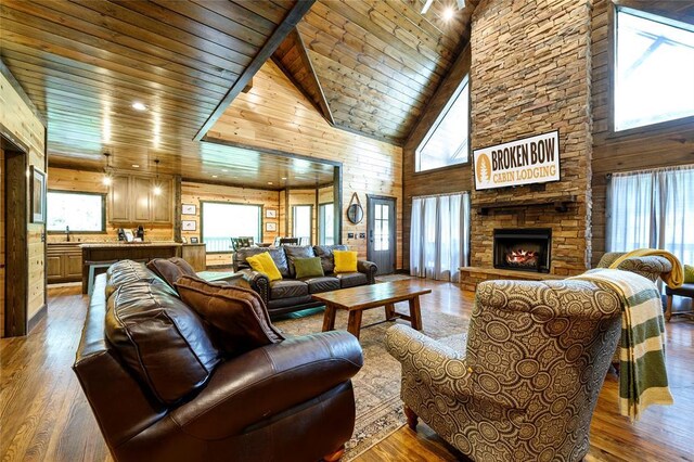 living room with a towering ceiling, a wealth of natural light, and hardwood / wood-style floors