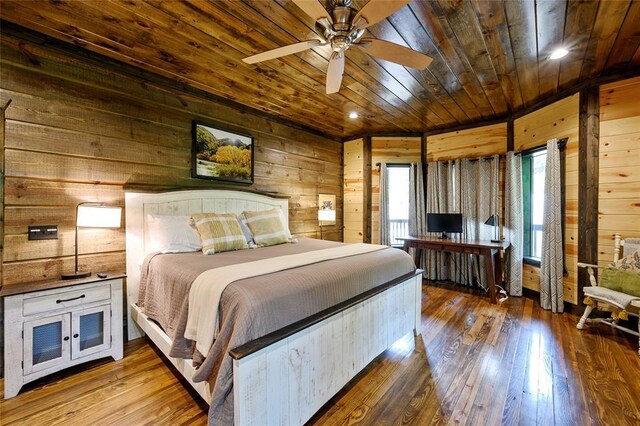 bedroom with wood ceiling, wooden walls, and hardwood / wood-style flooring