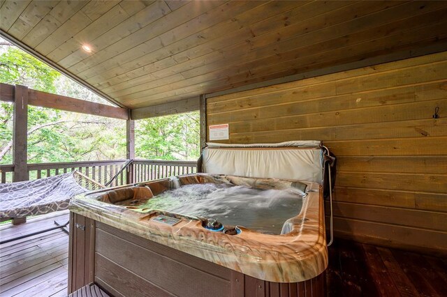 wooden terrace featuring a hot tub