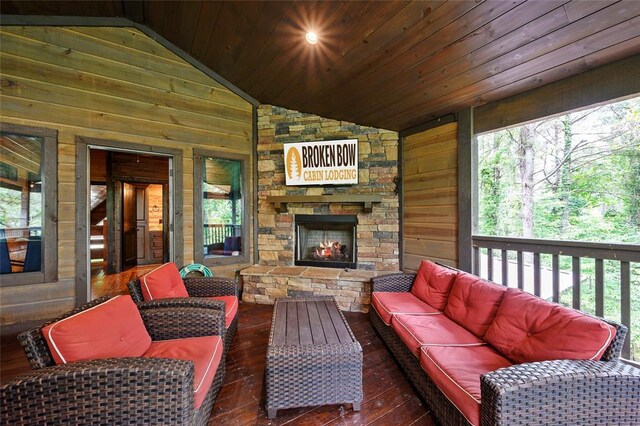 exterior space with an outdoor living space with a fireplace and a wealth of natural light
