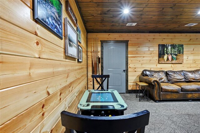 game room featuring wooden walls, visible vents, wood ceiling, and carpet