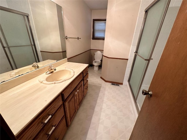 full bath featuring visible vents, a shower with shower door, tile patterned floors, vanity, and toilet