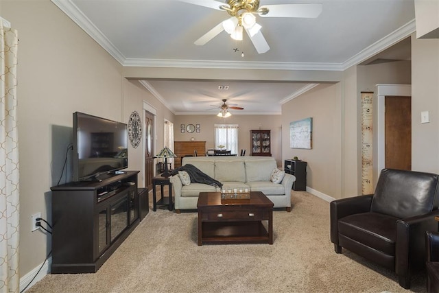 living room with crown molding, baseboards, ceiling fan, and carpet flooring