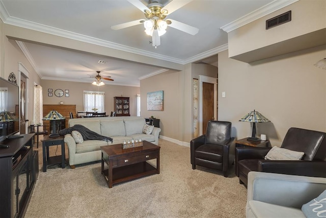 living area featuring a ceiling fan, visible vents, crown molding, baseboards, and light carpet